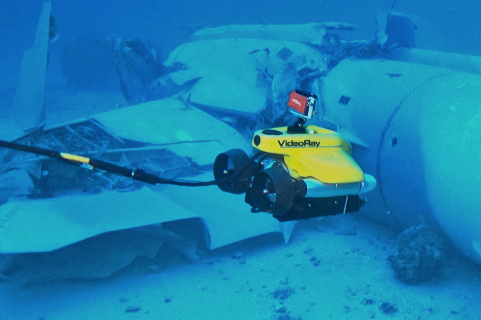 VideoRay ROV surveying a wreck underwater.